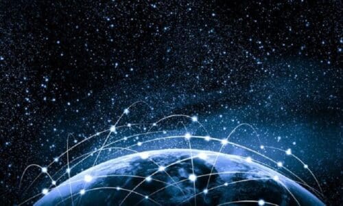 The earth from space with beams of light interconnected to depict a global network.