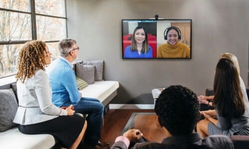 People in a conference room using HP & Poly devices certified for Microsoft Teams.