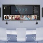 Q-SYS system with Microsoft Teams Rooms displayed on a screen in a conference room.