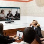 People in a hybrid meeting with Boom Aura intelligent video bar