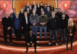 Audio production team posing on the 65th Grammys stage.