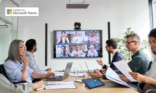 People attending a hybrid room meeting in a conference room.