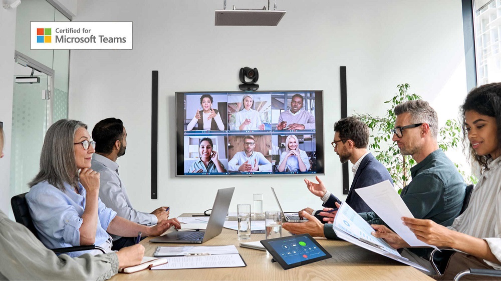 People attending a hybrid room meeting in a conference room.