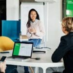 women talking with colleagues in meeting