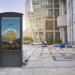 Peerless-AV smart city kiosk placed in front of a bus stand.