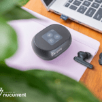 The Voyager Free 60 Series earbuds by Poly and powered by NuCurrent placed near a desktop.