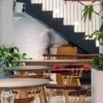 Interior of Fig at Malcha, Delhi. A blurred person is walking around the restaurant tables.