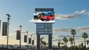 LED billboard displaying cars available for sale.