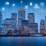 Buildings with overlay of digital network icons.