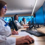 Matrox IP KVM, Female security guards working on computers while sitting in the main control room