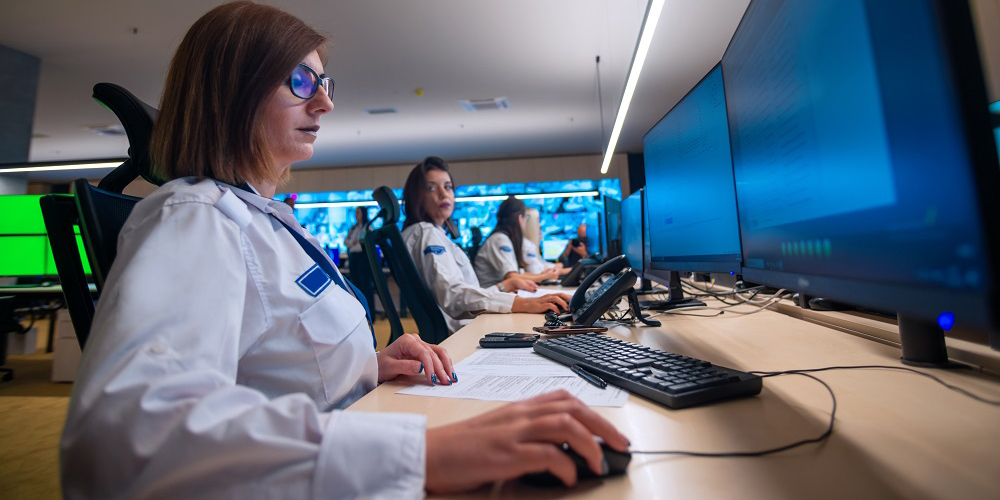 Matrox IP KVM, Female security guards working on computers while sitting in the main control room