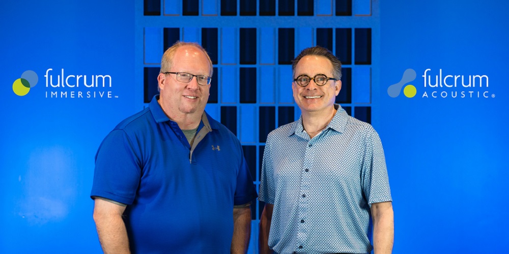 Dr. Paul Henderson and Stephen Siegel standing in front of Fulcrum Immersive backdrop.