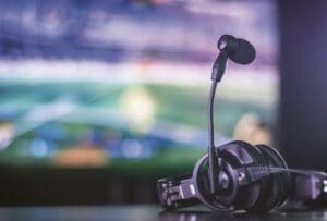 Headset resting on table with screen in background