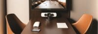 table with small videoconferencing camera setup, concept of Video Collaboration, created with Generative AI technology