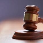 selective focus on gavel hammer on wooden table top with copy space