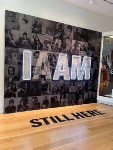 IAAM "Still Here" sign.