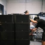 People moving L-Acoustics counterfeit products from warehouse.