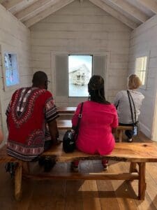 People sitting inside Prairie House of IAAM.