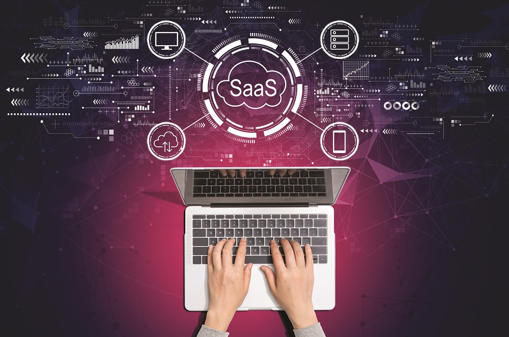 SaaS - software as a service concept with person using laptop