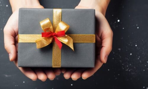 christmas background with hands holding present box background. Beautiful gift box on color background., tech gifts,