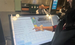 Amala utilizing the touch screen kiosk solution while at ACE in Portland, OR