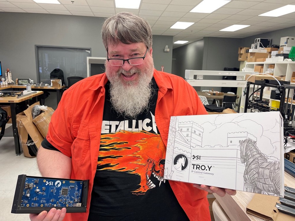 Michael Braithwaite posing with tech products.