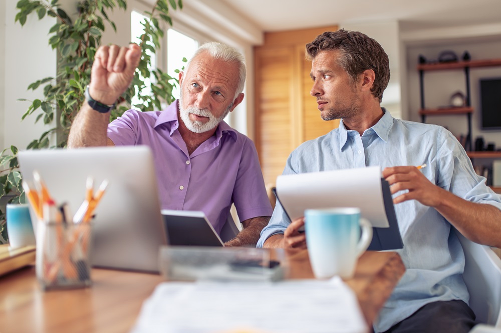 Image of two businessmen discussing about new project in modern office. Next-generation integration leadership