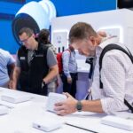 CEDIA Expo/CIX 2025 show floor with attendees at booths.