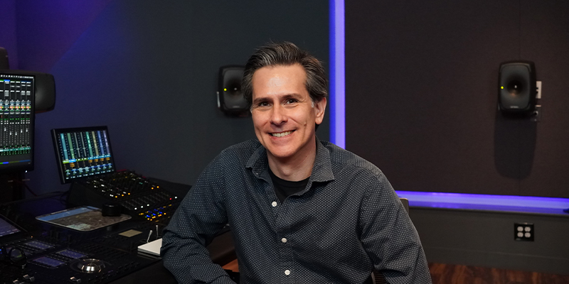 Paul Stewart of Genelec posing with Smart IP speakers