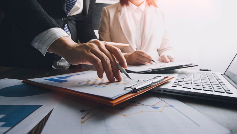 Businessman using tablet analyzing sales data and economic growth graph chart. Business strategy. Abstract icon. Digital marketing.